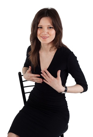 Beautifull young lady sitting on the chair and posing by handの写真素材