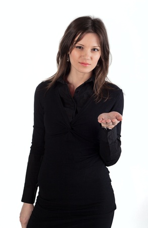 Young beautiful woman standing and holding hands for some offerの写真素材