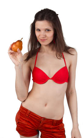Young lady in red dress with red pear in her handの写真素材