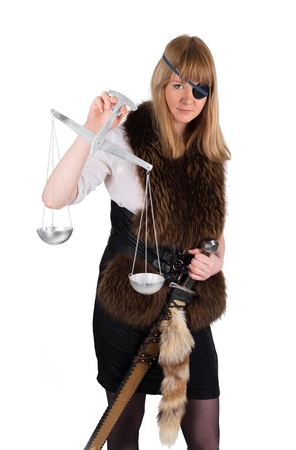 Young woman with balance and sword as Themis in robber dressの写真素材
