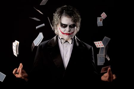 man in an image of a joker with cards on black backgroundのeditorial素材