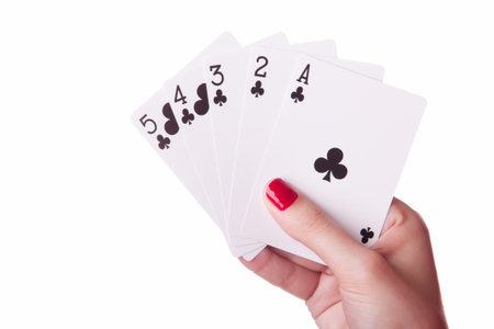 Straight Flush of clubs in hand isolated on the white background