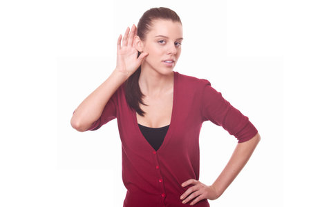young woman listen carefully whisper or gossip putting hand to ear