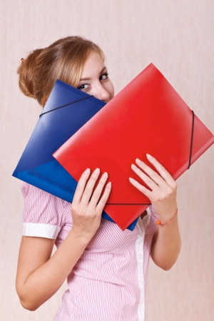 businesswoman covered his face folders with documentsの写真素材