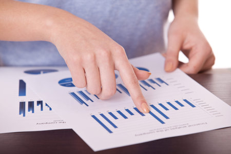 closeup female hands and business document with diagram