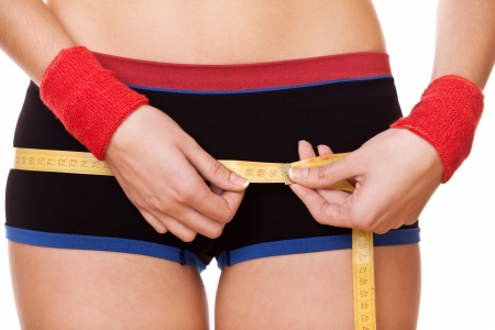 closeup woman measuring perfect shape of beautiful hips 90 centimetersの写真素材