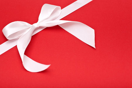 white bow on red background, holiday background