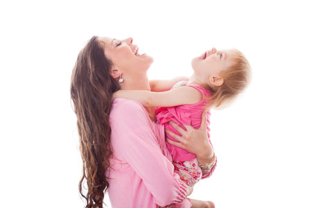 smiling happy mother and daughter on white background in studioの写真素材