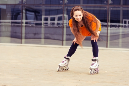teenager on roller skates on background modern buildingの写真素材