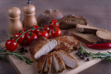 meat pork with tomato on wooden tableの写真素材