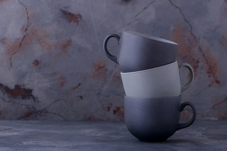 Set black and grey cups. Dinnerware on dark backgroundの写真素材