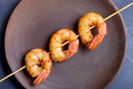 Tiger shrimp on skewer in plate. Closeup seafoodの写真素材