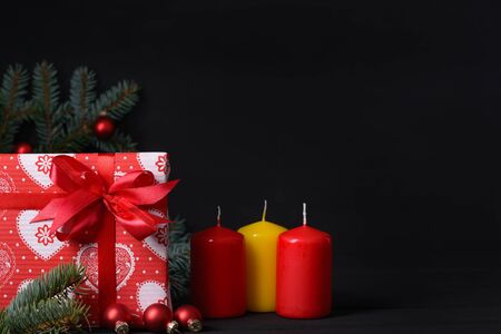 New Year greeting card. Gift box and candle with space for greetingsの写真素材