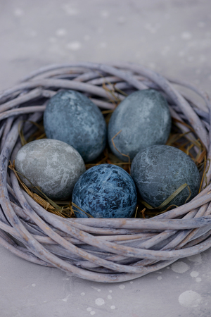 Easter eggs in the nest on stone background. Celebration cardの写真素材
