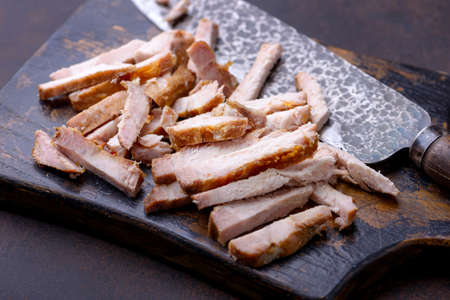 Close-up cooked sliced meat pork on cutting boardの写真素材