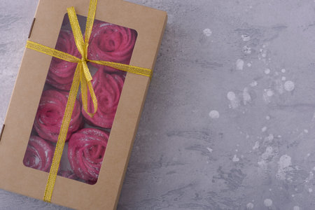 Sweet meringues in gift box. Top view on gray backgroundの写真素材