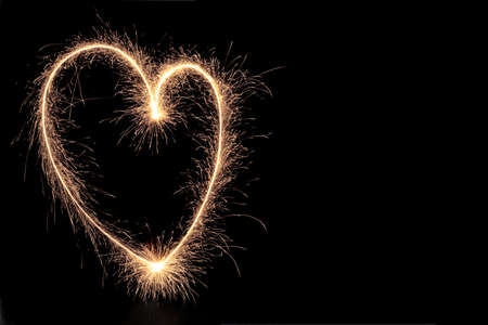 heart of sparks on a dark background, a symbol of love and happiness, valentine's day backgroundの写真素材