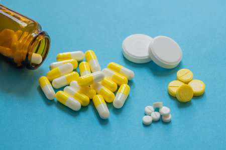 medicines on a blue background, different types of medicines, soluble tablets, medicinal powder in...