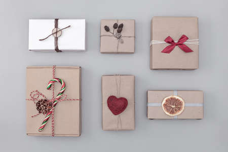 New Year gift wrapping of gifts in craft paper, top view layout, eco-friendly designの写真素材