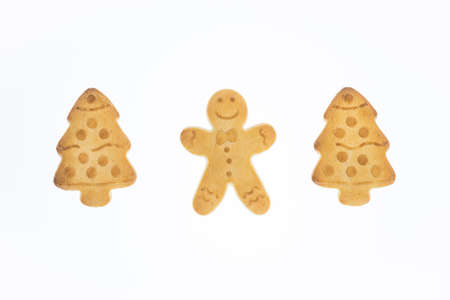 christmas shortbread cookies in the shape of a christmas tree and gingerbread man on a white background, tasty homemade cakes, christmas recipes, symbol of merry christmas and happy new yearの写真素材