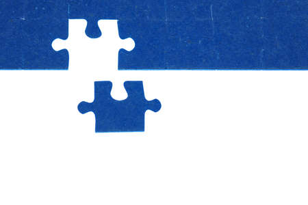 piece of blue jigsaw puzzle on a white background, the concept of the end of a big hard work, the solution of the problem, the final touchの写真素材