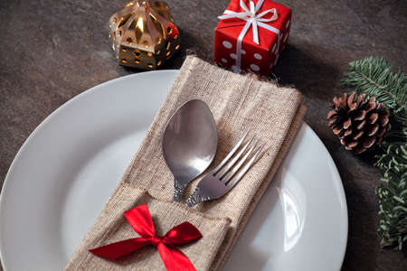 plate and cutlery with Christmas decorations, Christmas dinner, festive table setting, New Year's menuの写真素材
