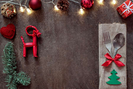 New Year table layout with cutlery and Christmas decor, home festive dinner, blank for design, free spaceの写真素材