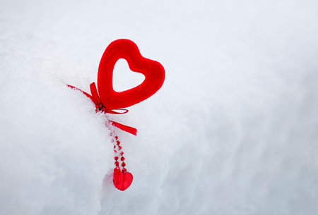 valentine's day background, red velvet heart on fluffy white snow, 14 februaryの写真素材