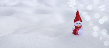 cute little snowman in red scarf and hat in the snow panorama, merry christmas background, happy new year backgroundの写真素材