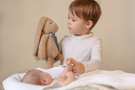 boy playing with his new baby sister, new addition to the family, big broの写真素材