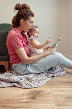 Young mother reading to her cute little baby