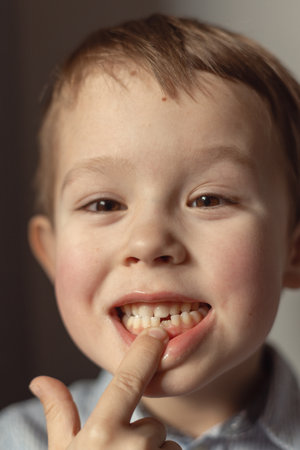 boy smiles showing his missing tooth,の写真素材