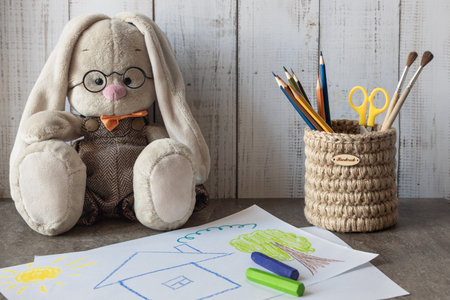 Children's desk with a picture on it, a hand-drawn house with crayonsの写真素材