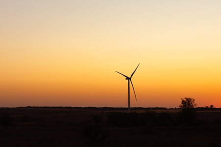 Wind turbine Silhouette of windmill at sunset. Wind generators on summer evening. Eco power plant....