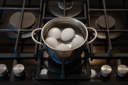 Saucepan with boiling eggs on a gas stove, egg cooking healthy eating concept, Eggs menu foodの写真素材