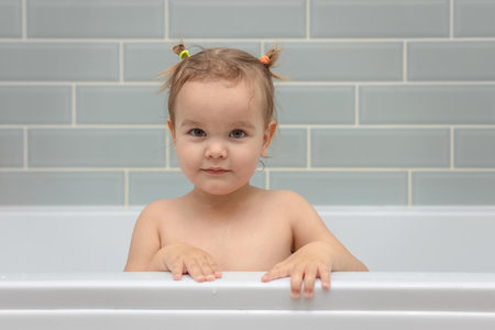 Baby girl in the bathroom, daily hygiene, daily routineの写真素材
