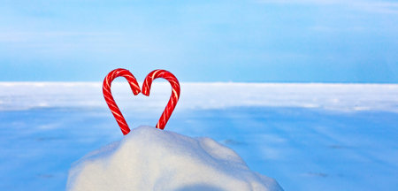 Candy heart on a frozen lake, endless snowy expanses, winter travel, winter background.