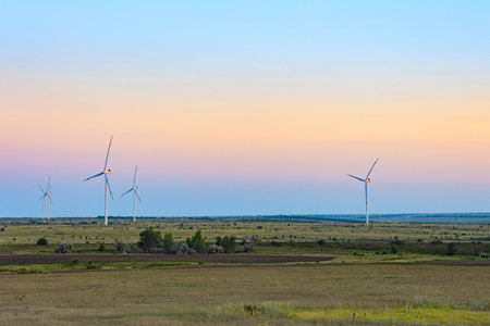 Wind turbines generate clean and sustainable electricity Beautiful, large, white wind turbines with...