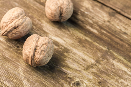 The natural organic walnuts lying on a rural table.