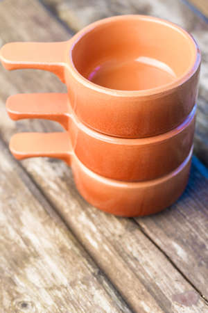 Empty clay bowls on an old wooden table.の写真素材