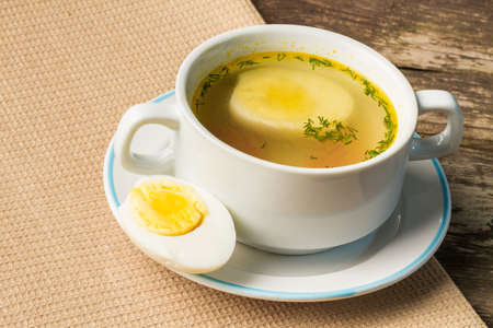 Home-made fresh chicken broth in a soup cup.の写真素材