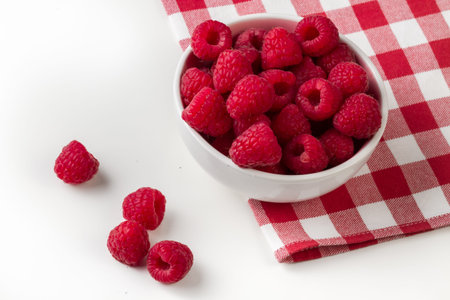 Fresh organic berries of raspberry on a white background.