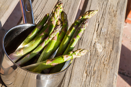 Fresh green asparagus on an old table.の写真素材