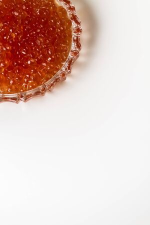 Red caviar of a salmon in a crystal saucer.の写真素材