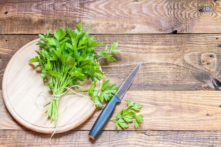Fresh organic farmer parsley on a round chopping board.の写真素材