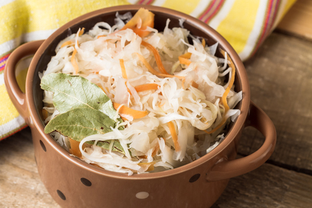 Organic homemade sauerkraut in a bowl on a wooden table.の写真素材