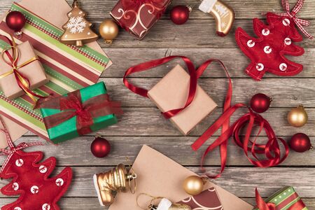 Christmas ornaments, gifts and wrapping paper on a gray wooden background.の写真素材