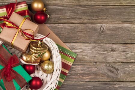 Christmas ornaments, gifts and wrapping paper on a gray wooden background.の写真素材
