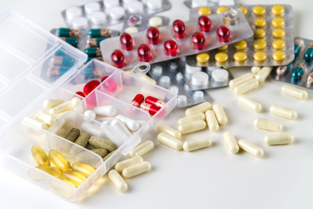 Various medical color capsules and pills on a white background.