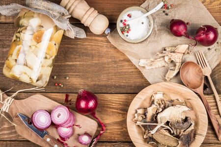 Homemade canned and dehydrated mushrooms on a wood background.の写真素材